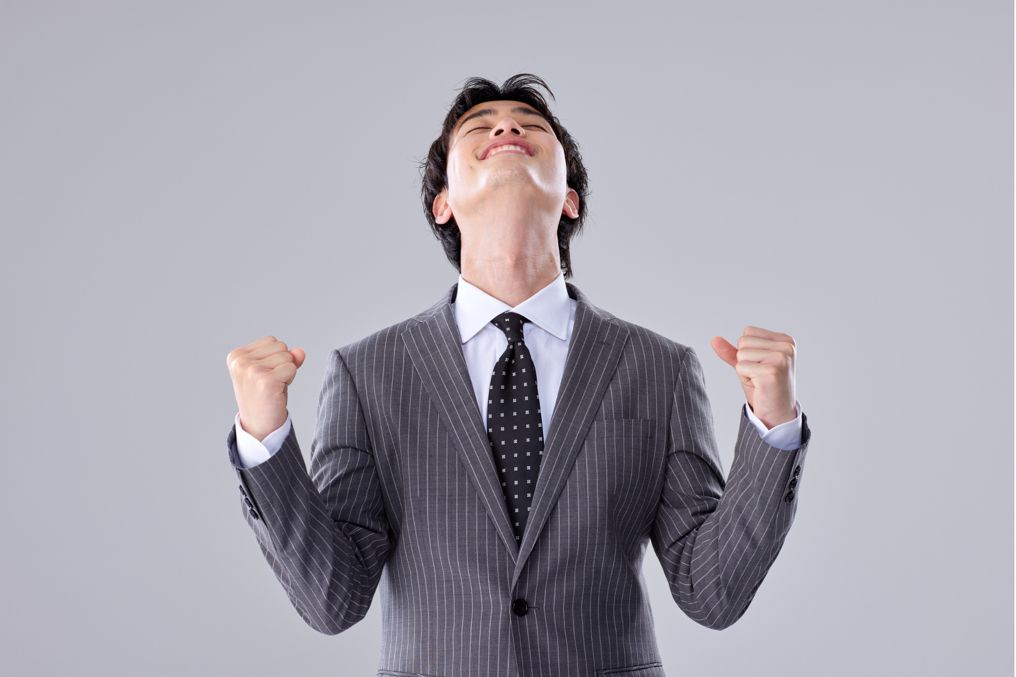 A triumphant professional celebrating success, symbolizing the transformative power of strengths-based coaching in unlocking confidence and achievement.