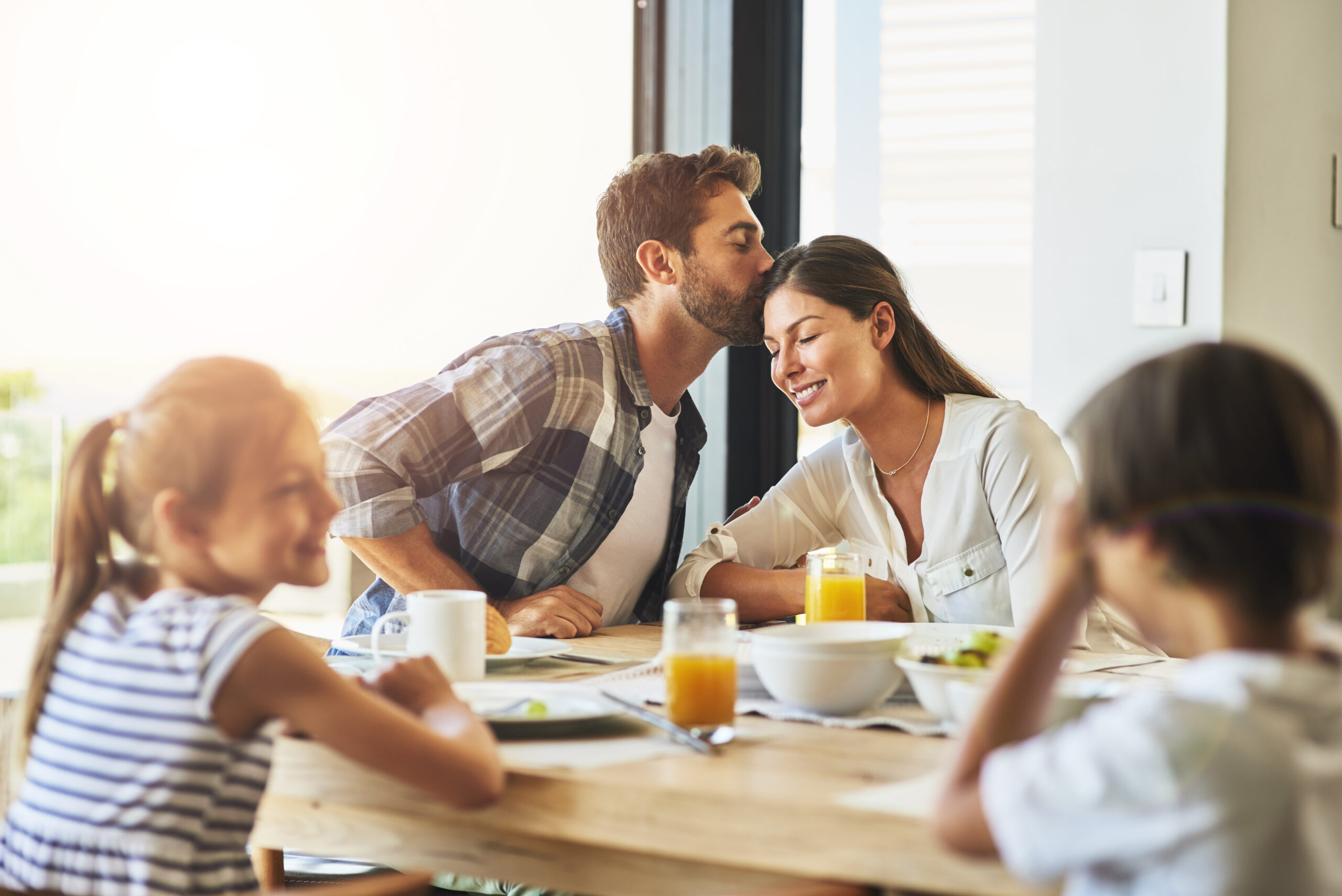 A loving family shares a joyful breakfast, illustrating the power of healthy relationships built on clear boundaries, open communication, and emotional connection.